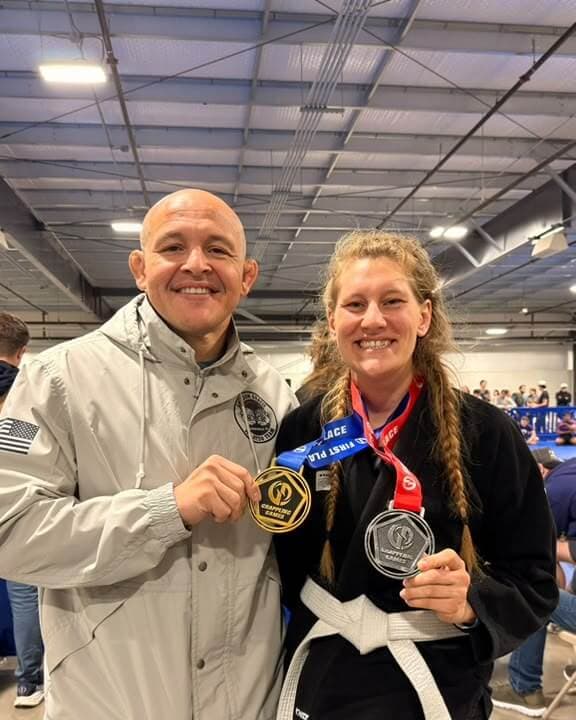 Professor Paraíba and a student holding their medals at an IBJJF tournament