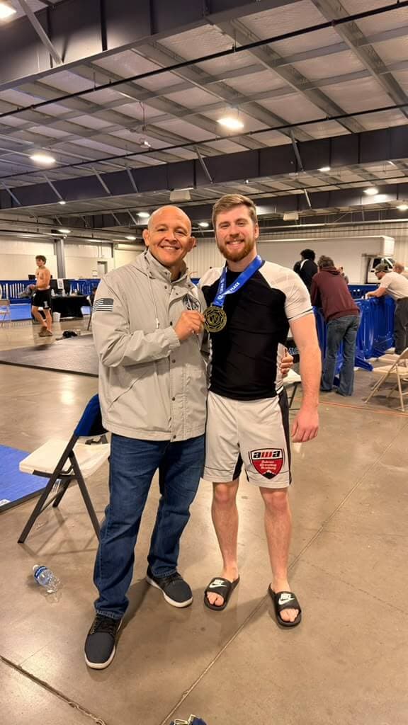 Professor Paraíba with a student and his medal at a jiu-jitsu tournament