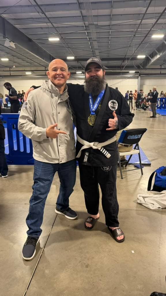 Professor Paraíba with a student and his medal at a tournament